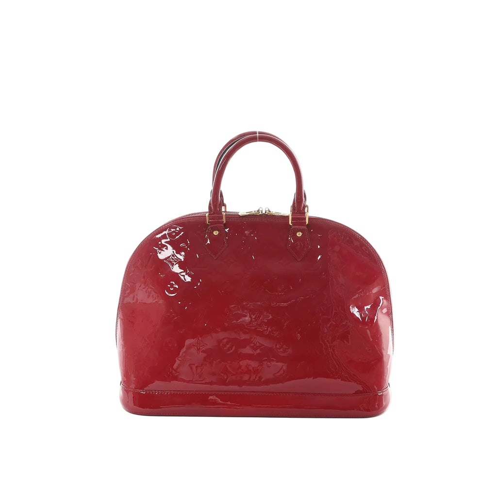 Louis Vuitton Alma GM handbag in glossy red Vernis patent leather with embossed Monogram, top handles, and gold-tone hardware on a white background.