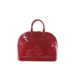 Louis Vuitton Alma GM handbag in glossy red Vernis patent leather with embossed Monogram, top handles, and gold-tone hardware on a white background.