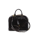 Louis Vuitton Alma MM handbag in glossy amarante Vernis patent leather with embossed monogram, top handles, detachable shoulder strap, and gold-tone padlock, front view on white background