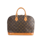 Louis Vuitton Alma PM handbag in brown Monogram canvas with tan leather top handles and vachetta leather base on white background