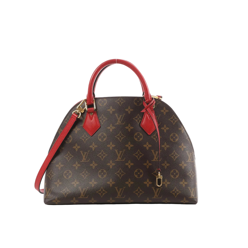 Louis Vuitton Alma B'N'B brown Monogram canvas handbag with red leather top handles, red shoulder strap, and gold-tone hardware on a white background