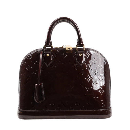 Front view of a Louis Vuitton Alma PM handbag in Amarante Monogram Vernis patent leather featuring embossed monogram, dual top handles, structured silhouette, gold-tone hardware, and a clochette.