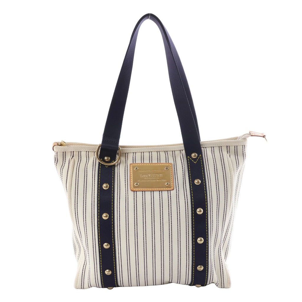 Louis Vuitton Antigua Cabas MM tote in blue-and-cream striped canvas with navy handles, gold-tone studs and a rectangular logo plaque