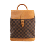 Louis Vuitton Damier Ebene Arlequin Backpack N99038 in brown checkered coated canvas with natural Vachetta leather flap, top handle, buckle strap closure, and leather base, displayed upright against a white background.