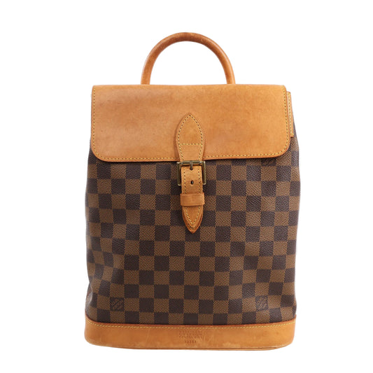 Louis Vuitton Damier Ebene Arlequin Backpack N99038 in brown checkered coated canvas with natural Vachetta leather flap, top handle, buckle strap closure, and leather base, displayed upright against a white background.
