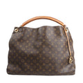 Louis Vuitton Artsy GM shoulder bag in brown Monogram canvas featuring the signature LV and floral pattern, braided leather handle, and gold-tone hardware accents.