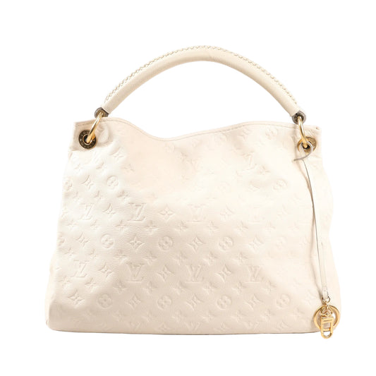 Front view of a Louis Vuitton Artsy MM M93449 shoulder bag in beige Monogram Empreinte leather with embossed LV monogram, single braided top handle, gold-tone hardware, and decorative charm.
