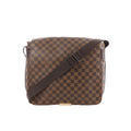 Louis Vuitton Damier Ebene brown check messenger bag with flap front and wide adjustable shoulder strap on a white background.