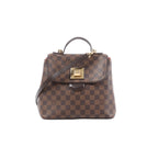 Louis Vuitton Bergamo PM Damier Ebene handbag with top handle, detachable shoulder strap, flap front, and gold-tone clasp hardware on a white background.