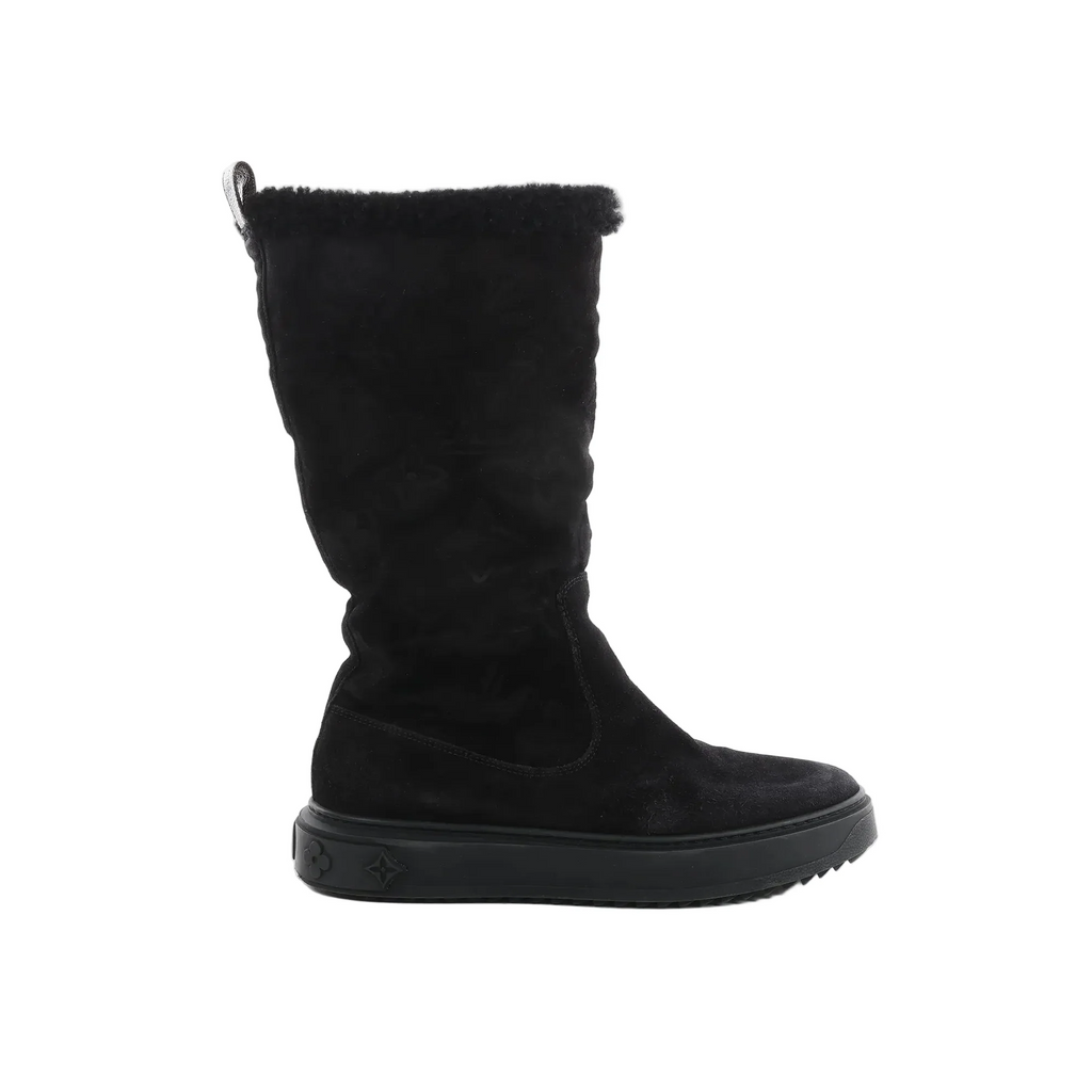 Louis Vuitton black suede mid-calf boot with sheepskin trim at the top and black rubber sole with Monogram motifs on white background