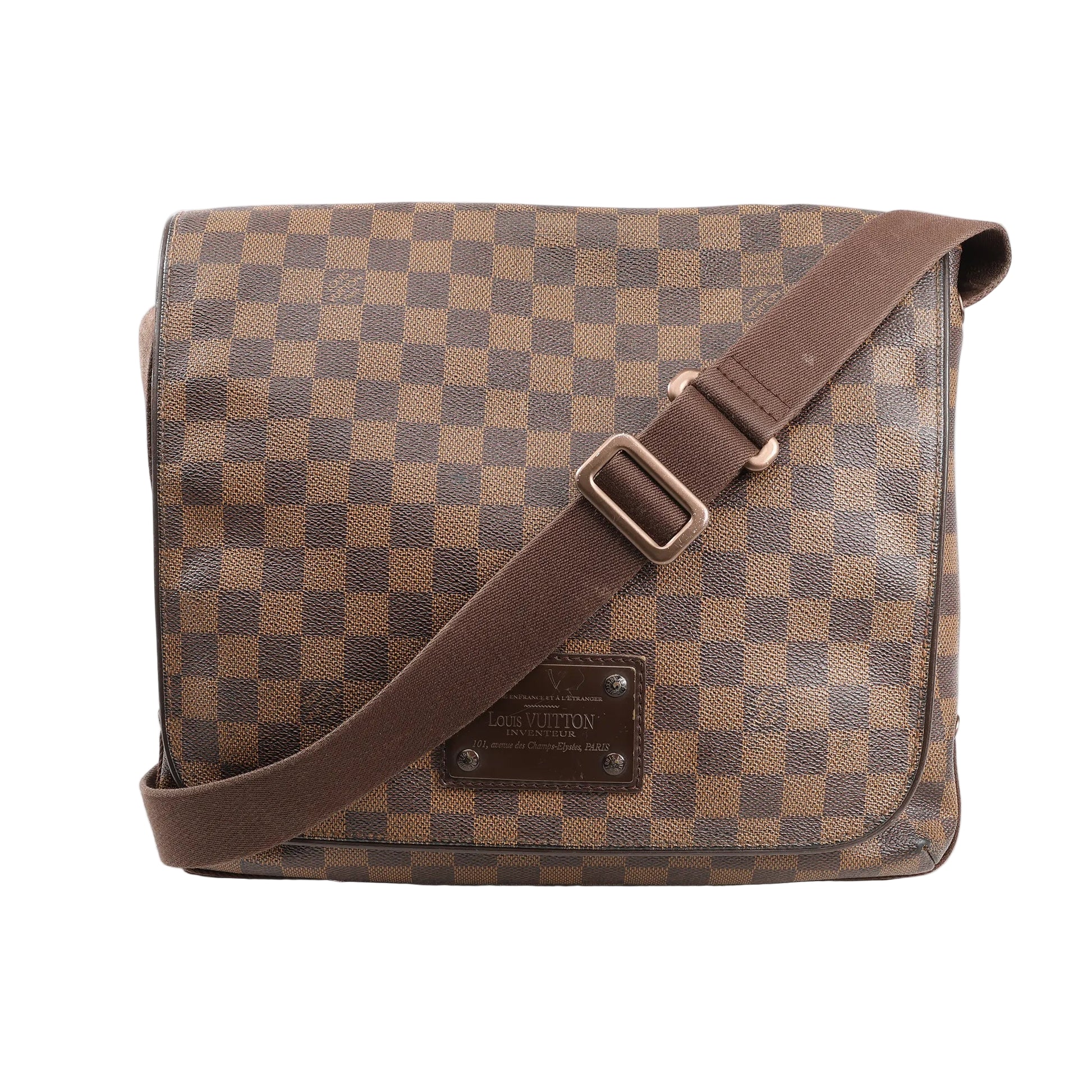 Louis Vuitton Brooklyn MM crossbody bag in brown Damier Ebene coated canvas with front logo plate, flap closure, and adjustable brown fabric strap.