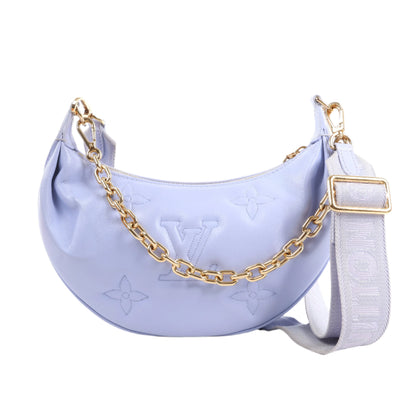 Light purple handbag with gold chain and strap on a white background