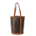 Louis Vuitton Bucket GM shoulder bag in brown Monogram canvas with tan leather trim, long adjustable straps and a round structured base.
