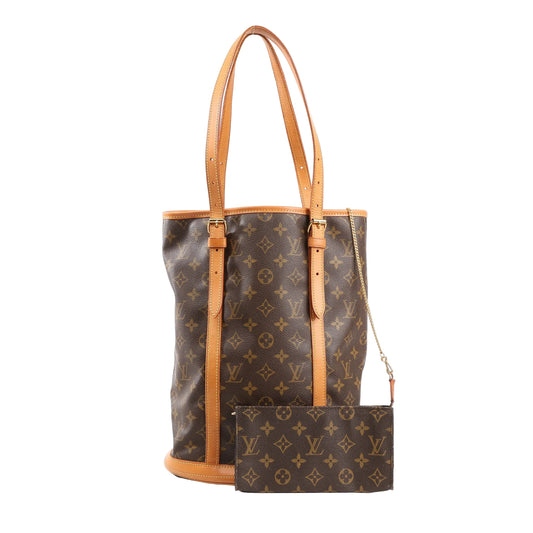 Louis Vuitton Monogram Canvas Bucket GM Shoulder Bag M42236 with brown LV monogram canvas, natural leather trim and handles, adjustable straps, and matching detachable pouch, displayed upright on a white background.