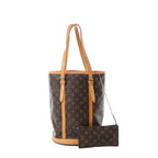 Louis Vuitton Bucket GM tote bag in brown Monogram coated canvas with natural leather trim, adjustable shoulder straps and matching Monogram zip pouch on a white background.