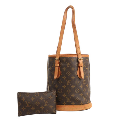 Front view of a Louis Vuitton Bucket PM shoulder bag in brown Monogram canvas with tan vachetta leather trim and two adjustable shoulder straps, shown with a matching monogram zip pouch in front on a white background.