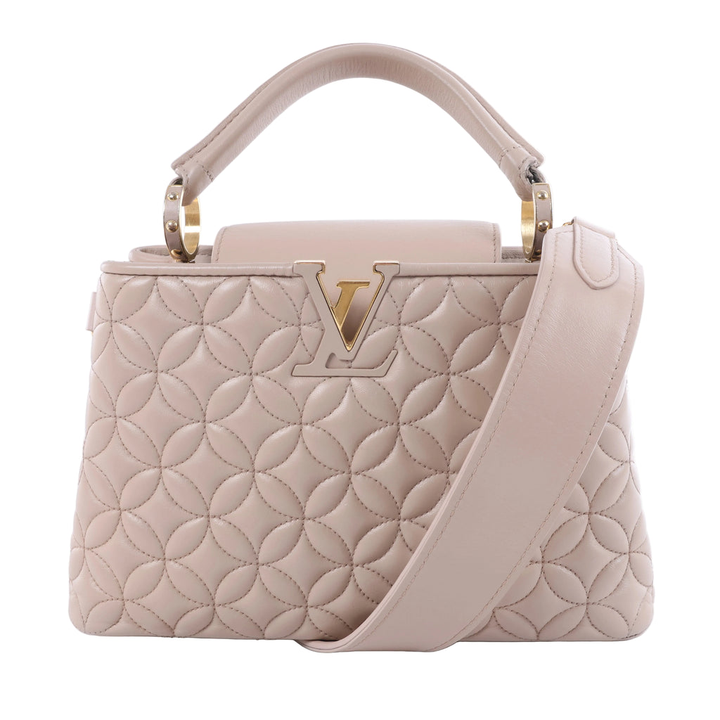 Louis Vuitton Capucines BB beige quilted leather handbag with floral stitching, gold-tone LV closure, top handle and wide shoulder strap.