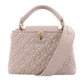 Louis Vuitton Capucines BB beige quilted leather handbag with floral stitching, gold-tone LV closure, top handle and wide shoulder strap.