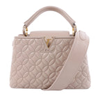 Louis Vuitton Capucines BB beige quilted leather handbag with floral stitching, gold-tone LV closure, top handle and wide shoulder strap.