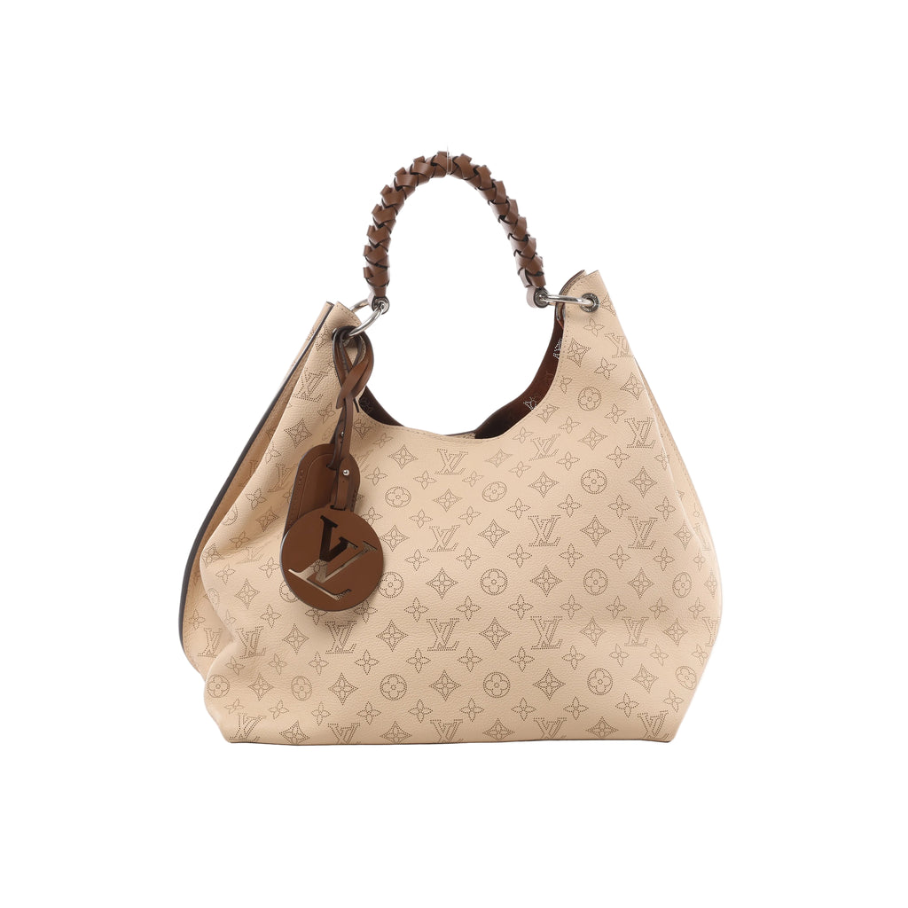 Crème Louis Vuitton Carmel hobo bag in perforated Mahina leather with brown braided handle, LV charm and silver-tone ring hardware.
