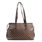 Louis Vuitton Damier Ebene Chelsea Shoulder Bag N51119 featuring brown checkered canvas, long adjustable dark brown leather shoulder straps with gold-tone buckles, and a roomy rectangular silhouette, displayed upright on a white background.