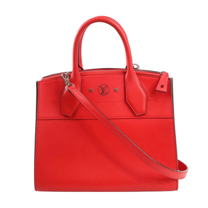 Louis Vuitton City Steamer PM 2Way handbag M51030 in vibrant red Taurillon leather, featuring top handles, detachable shoulder strap, silver-tone hardware, zip closure, and LV logo stamp on the front panel.