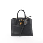 Louis Vuitton City Steamer PM black leather handbag with top handles, detachable shoulder strap, zip-top closure, LV luggage tag, and gold-tone padlock on white background