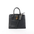 Louis Vuitton City Steamer PM black leather handbag with top handles, detachable shoulder strap, zip-top closure, LV luggage tag, and gold-tone padlock on white background