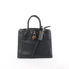 Louis Vuitton City Steamer PM black leather handbag with top handles, detachable shoulder strap, zip-top closure, LV luggage tag, and gold-tone padlock on white background
