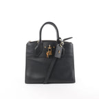 Louis Vuitton City Steamer PM black leather handbag with top handles, detachable shoulder strap, zip-top closure, LV luggage tag, and gold-tone padlock on white background