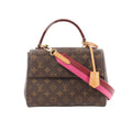 Louis Vuitton Cluny BB handbag in brown Monogram canvas with top handle and detachable shoulder strap featuring a pink underside and tan leather details.