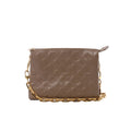Beige Louis Vuitton Coussin PM shoulder bag with embossed Monogram pattern, rectangular shape, top zip closure and gold-tone chain strap.