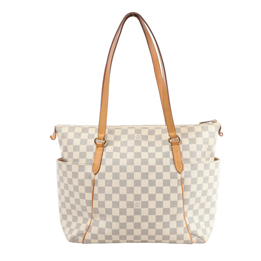 Louis Vuitton Damier Azur Totally MM shoulder bag in light checkered coated canvas with tan leather handles, trim, and side pockets, featuring gold-tone hardware and a zip closure.