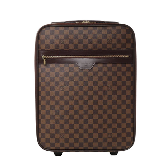 Front view of Louis Vuitton Damier Pégase 45 suitcase N23293 in brown checkered coated canvas, featuring dark brown leather trim, front zip pocket, gold-tone hardware, and two rolling wheels against a white background
