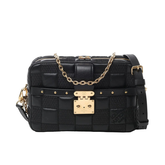 Front view of the Louis Vuitton Damier Quilt Troca MM Crossbody Bag M59114 in black, showcasing quilted lambskin in a checkerboard pattern, gold-tone S-lock clasp, decorative rivets, chain and leather strap, and a structured rectangular silhouette.