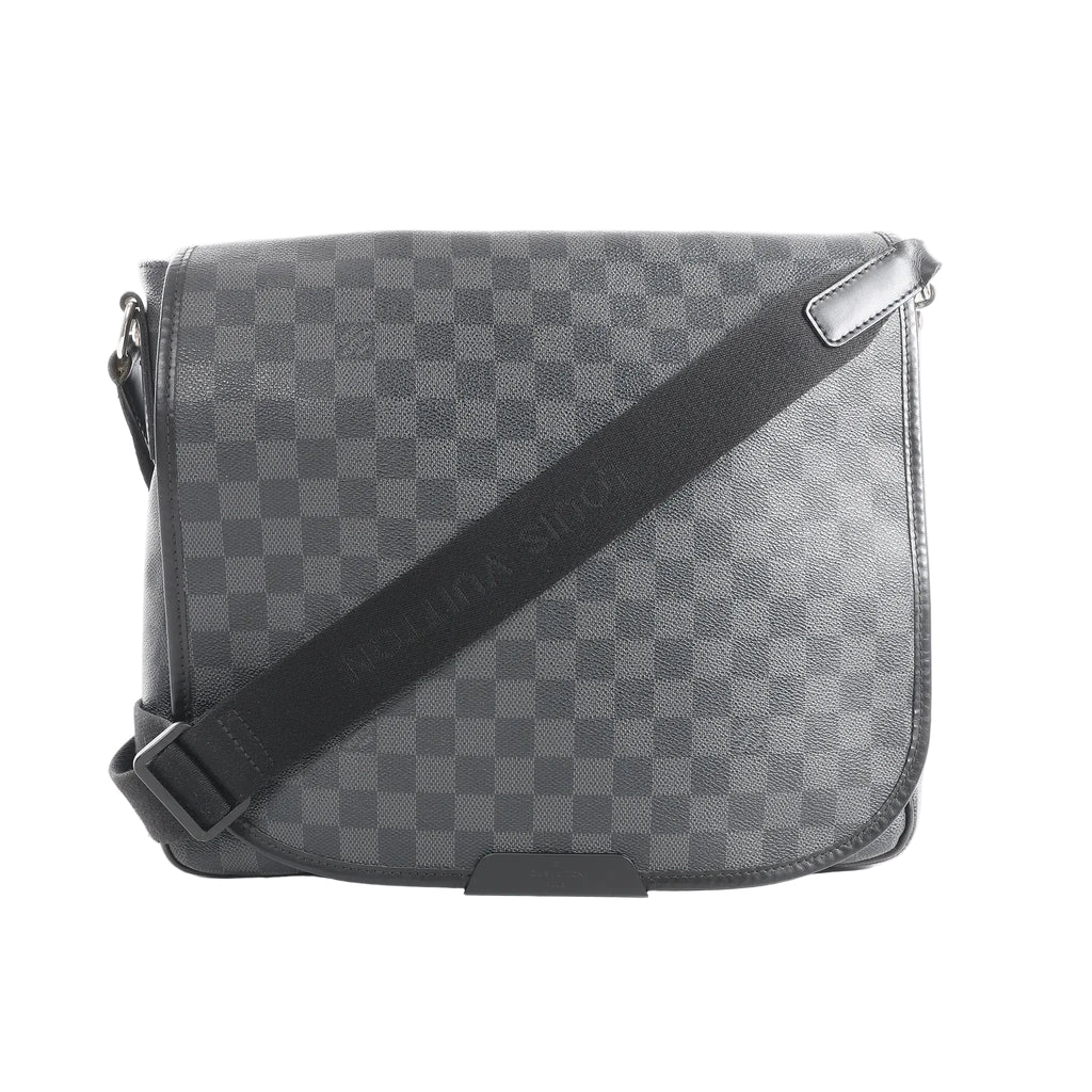 Louis Vuitton Daniel MM crossbody bag in black Damier Graphite canvas with flap front, black trim, and adjustable black shoulder strap.
