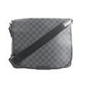 Louis Vuitton Daniel MM crossbody bag in black Damier Graphite canvas with flap front, black trim, and adjustable black shoulder strap.