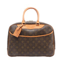 Louis Vuitton Deauville handbag in brown Monogram coated canvas with natural cowhide leather trim, rolled top handles, luggage tag, front slip pocket, and gold-tone hardware on a white background.