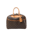 Louis Vuitton Deauville handbag in brown Monogram canvas with tan vachetta leather top handles and trim, zip-top closure with padlock, and leather luggage tag, front view on white background.