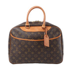 Louis Vuitton Deauville handbag in brown Monogram canvas with tan rolled handles, front pocket, luggage tag and gold-tone zip hardware.