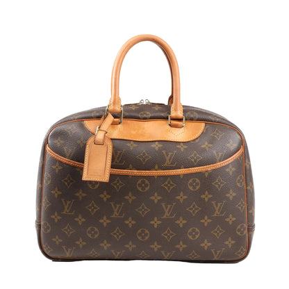 Louis Vuitton Deauville handbag M47270 in brown Monogram canvas with natural leather trim and top handles, front slip pocket, luggage tag, and structured dome shape.