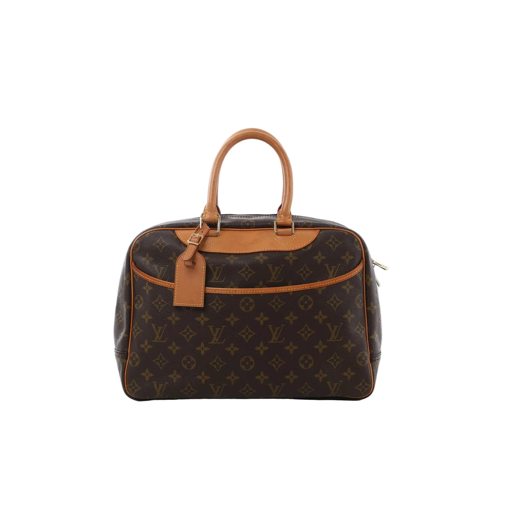 Louis Vuitton Deauville handbag in brown Monogram canvas with tan vachetta leather trim, top handles, and hanging leather luggage tag on a white background.