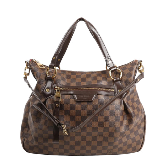 Front view of a Louis Vuitton Evora MM 2Way shoulder bag in brown Damier Ebene canvas, featuring rolled leather handles, adjustable crossbody strap, front zip pocket, and gold-tone hardware.