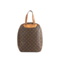 Louis Vuitton Excursion brown Monogram canvas handbag with natural leather top handles, zip-around sides, and leather trim on a white background
