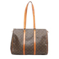 Louis Vuitton Flanerie 45 shoulder bag in brown Monogram coated canvas with natural cowhide leather straps and trim, gold-tone hardware, and zip top closure on a white background.