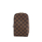 Front view of Louis Vuitton Geronimos bag in brown Damier Ebene canvas with zip-top closure and adjustable strap visible behind.