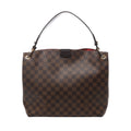 Brown Louis Vuitton Graceful PM Damier Ebene shoulder bag with dark leather strap, gold-tone eyelets and a glimpse of red lining.