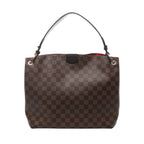 Brown Louis Vuitton Graceful PM Damier Ebene shoulder bag with dark leather strap, gold-tone eyelets and a glimpse of red lining.