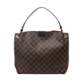 Brown Louis Vuitton Graceful PM Damier Ebene shoulder bag with dark leather strap, gold-tone eyelets and a glimpse of red lining.