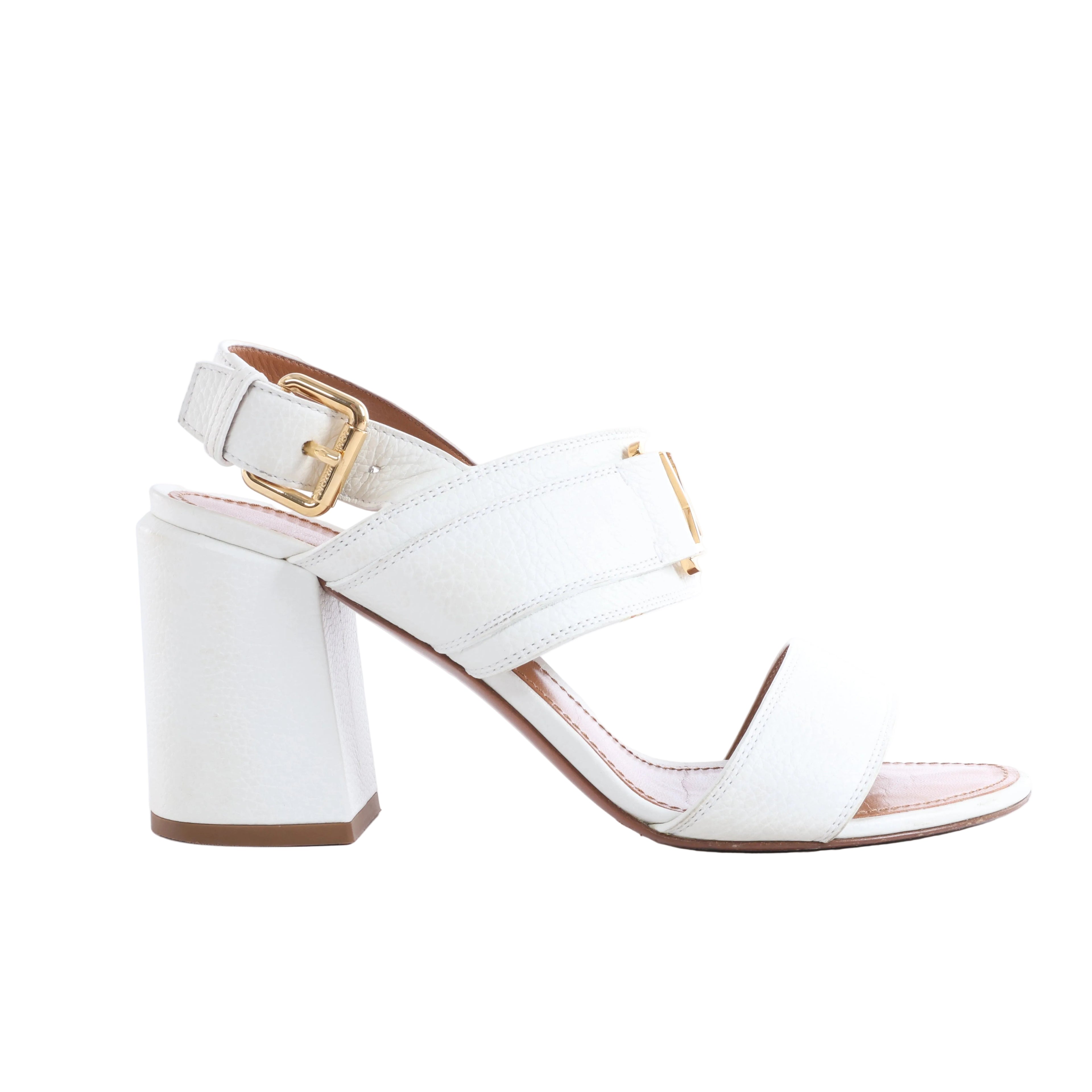 Louis Vuitton white leather sandal with crossover straps, gold-tone hardware, adjustable ankle buckle and chunky block heel.